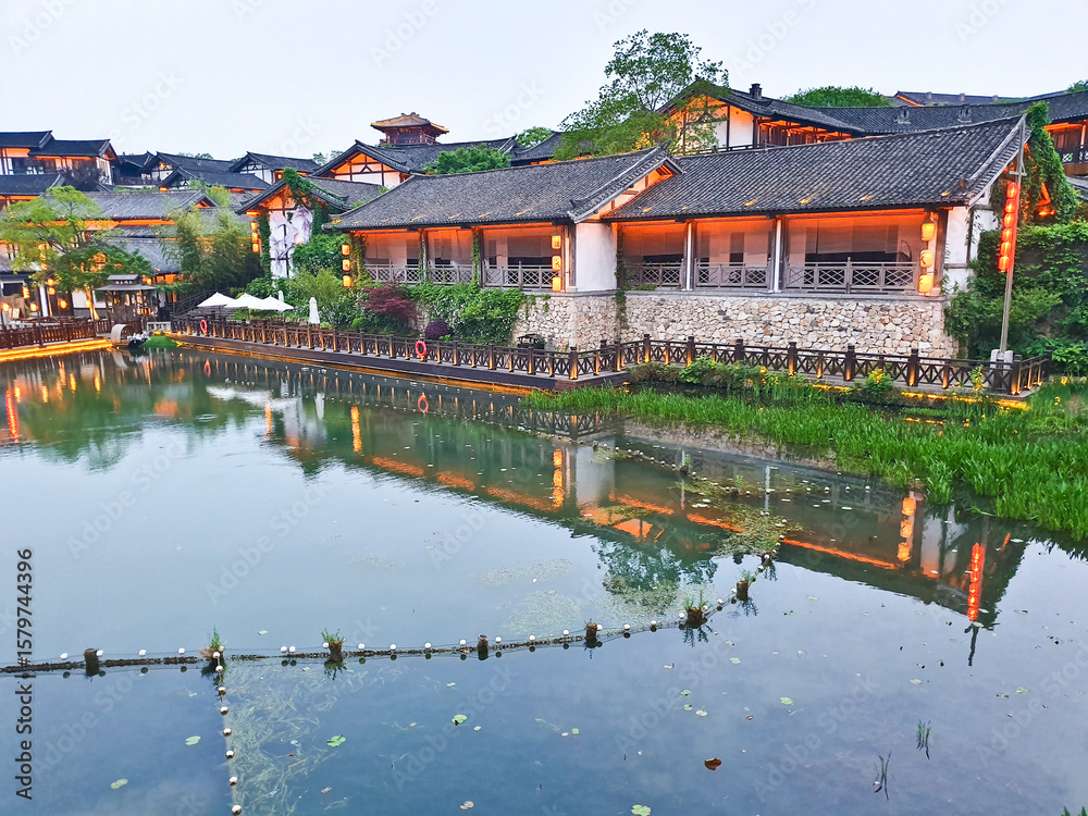 A tranquil canal scene at dusk with traditional Chinese buildings, soft lights reflecting in water, surrounded by nature and architecture
A tranquil canal scene at dusk with traditional Chinese buildings, soft lights reflecting in water, surrounded by nature and architecture