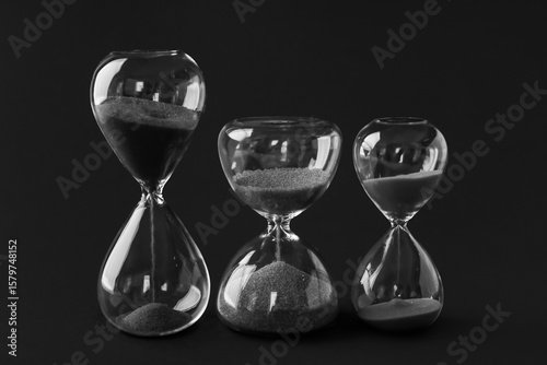 Crystal hourglasses on black background