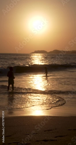 People's sihouetes at sunset in the beach