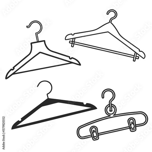 Four black and white clothing hangers and a safety pin apparel garment