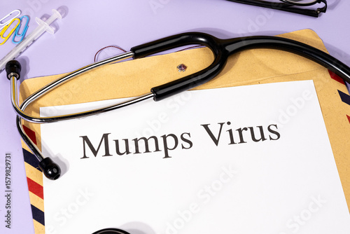 Obraz na płótnie A Paper with “Mumps Virus” Title in Clipboard Set on the Desk with Stethoscope –
