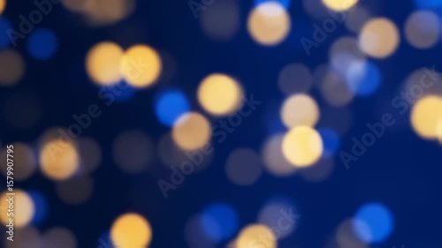 Abstract Christmas lights bokeh background with gold and blue festive glow
