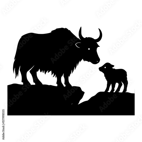 Silhouette of a mother yak and calf standing on rocks with mountains behind