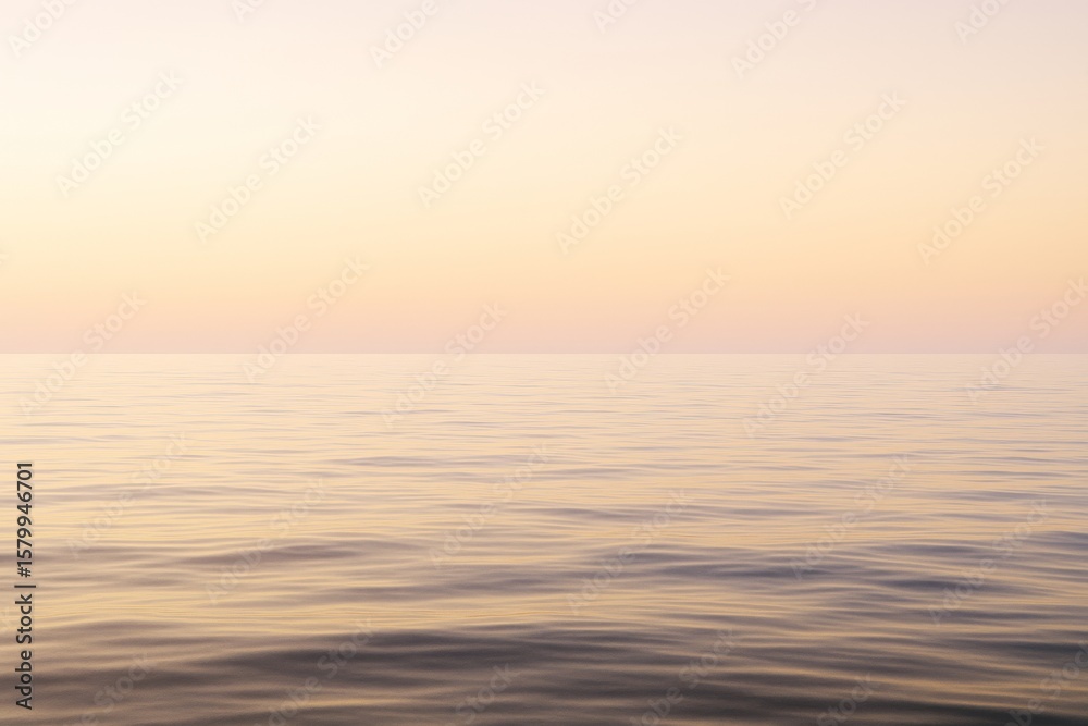 Obraz premium Tranquil seascape with soft pastel light at sunset creating a peaceful natural background over calm ocean horizon in a minimal landscape scene.