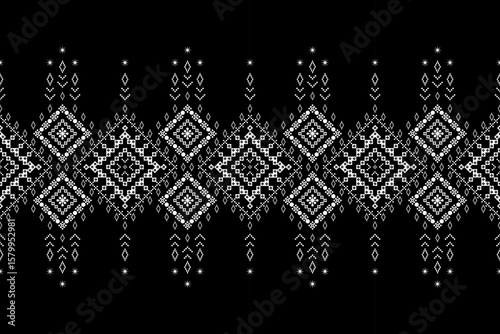 Intricate monochrome black and white ethnic pixel border pattern with geometric diamond ,dangling motifs. Ideal for tribal-inspired garment trims, textile accents,cultural decorative elements,fabric