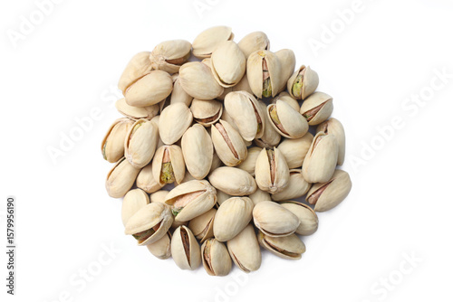A healthy pile of roasted, salted in-shell pistachio nuts on a white background.