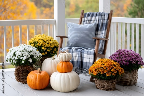 Pumpkins and chrysanthemum decorating a cozy porch during fall season