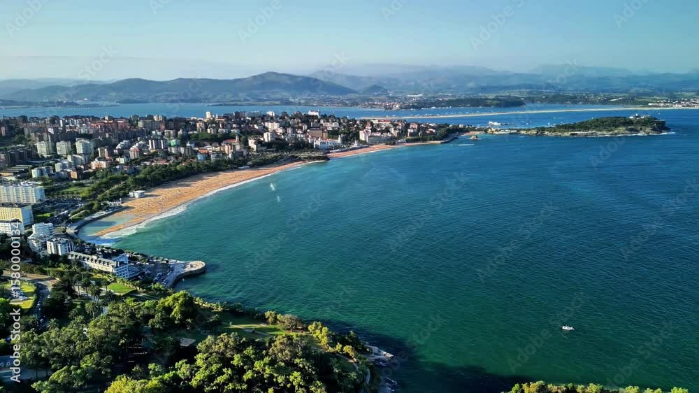 The breathtaking aerial view beautifully showcases a stunning cityscape, sandy beach, and serene waters The breathtaking aerial view beautifully showcases a stunning cityscape, sandy beach, and serene waters