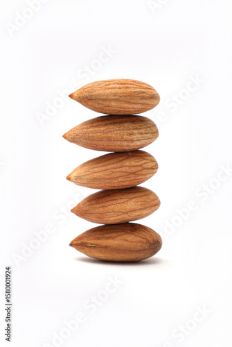 A perfectly balanced stack of whole raw almonds, a healthy nutritious superfood snack ingredient.