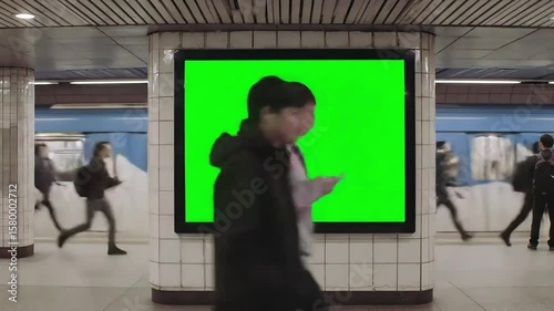 Blank Digital Billboard with Green Screen at Subway Train Station Platform for Advertising Mockup and Chroma Key Integration
