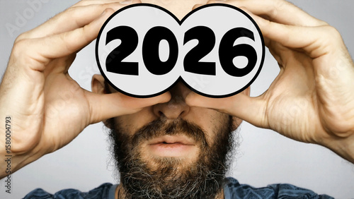 Quadro su tela Close-up of a bearded man holding depicted binoculars to his eyes with the big n