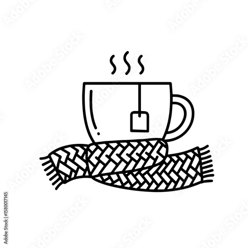 A steaming teacup rests on a knitted scarf
