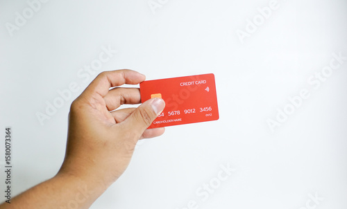 Close up of hand with red credit card isolated on white background. Shopping, finance and people concept