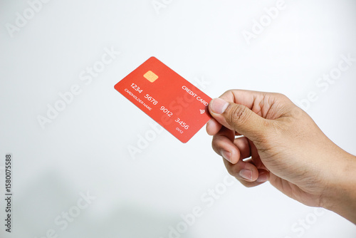 Close up of hand with red credit card isolated on white background. Shopping, finance and people concept