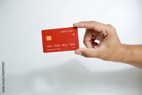 Close up of hand with red credit card isolated on white background. Shopping, finance and people concept