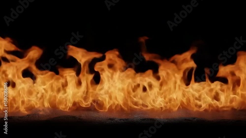 A black background with a long line of orange flames. The flames are very close to the camera, making them appear larger than they actually are. Concept of danger and intensity