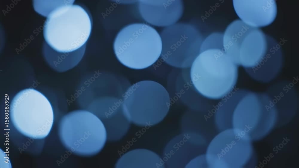 Soft glowing circles drift across a dark, blurred field, forming a tranquil and abstract composition. The gentle light and smooth transitions evoke calm, elegance, and visual harmony.