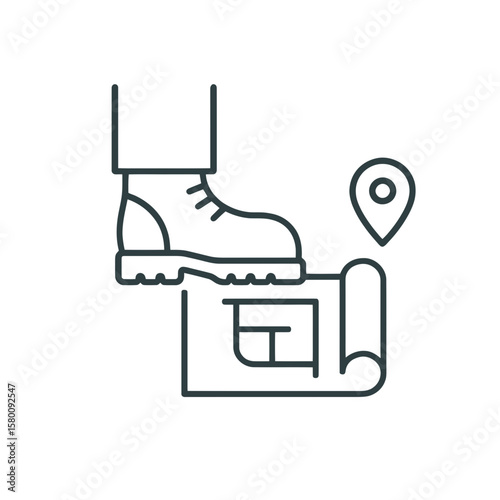A boot steps on construction plans next to location pin, ideal for concepts like bad land development and property mistakes.