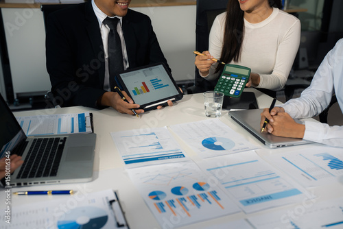 Close up Busines swoman and partner using calculator and laptop for calculation finance, tax, accounting, statistics and analytic research concept.