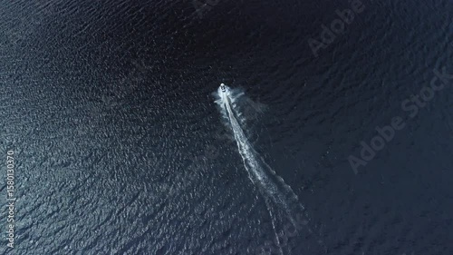 Jet ski aerial ride across water surface lake