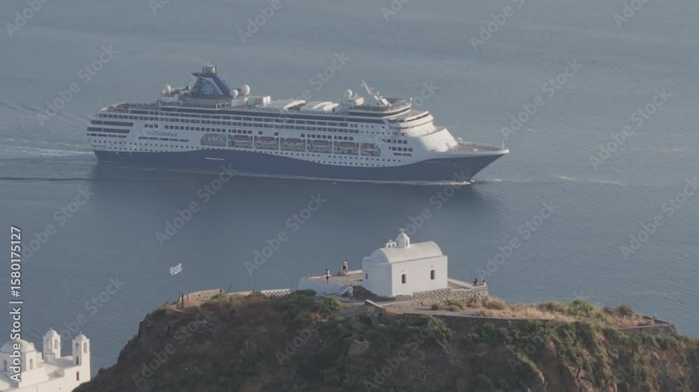Tight compressed aerial view of Plaka castle in Milos Greece, with ship sailing in the background. 3x telephoto, D-Log M profile