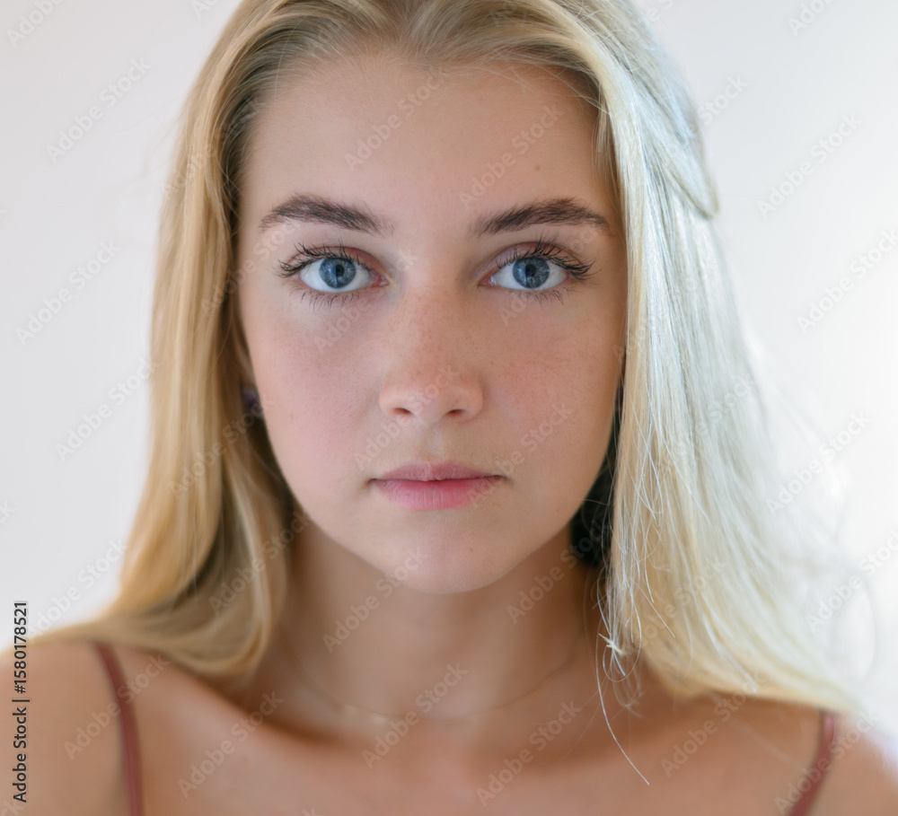Naklejka premium Portrait of beautiful sensual woman with blue eyes. Studio shot.