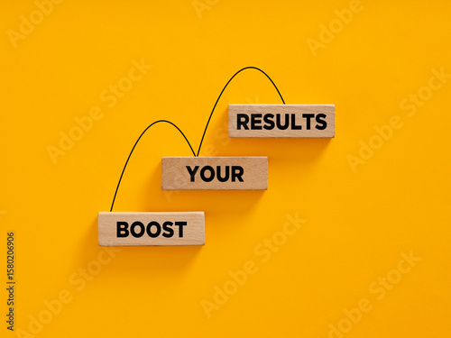 Fotografie Boost your results using a catapult on a yellow background
