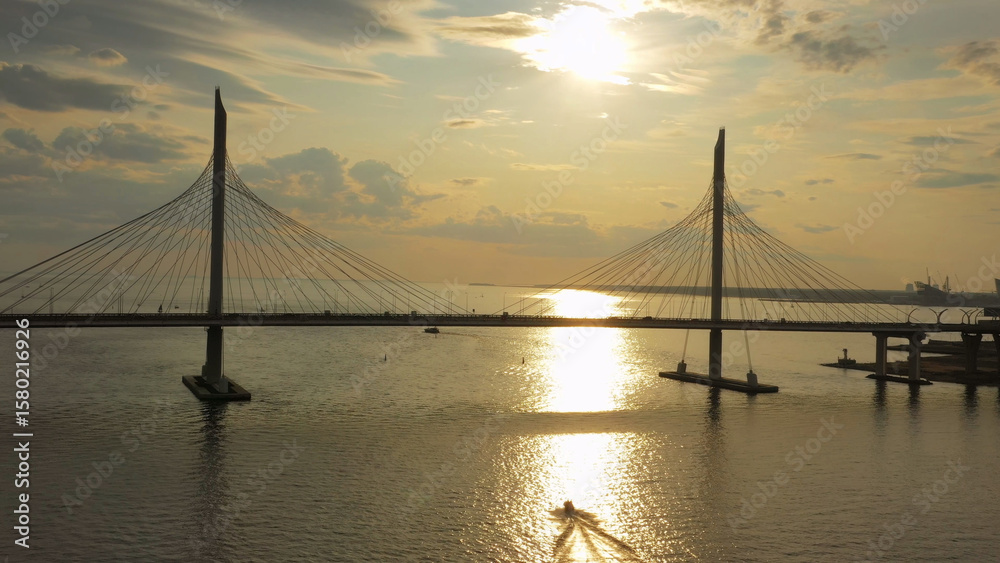 Obraz premium Cable-stayed bridge and new skyscraper at sunset