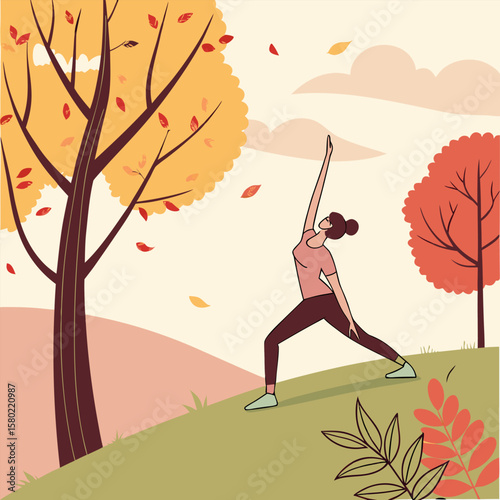 A woman practices yoga warrior ii pose outdoors on a grassy hill amidst falling autumn leaves and colorful trees under a soft sky