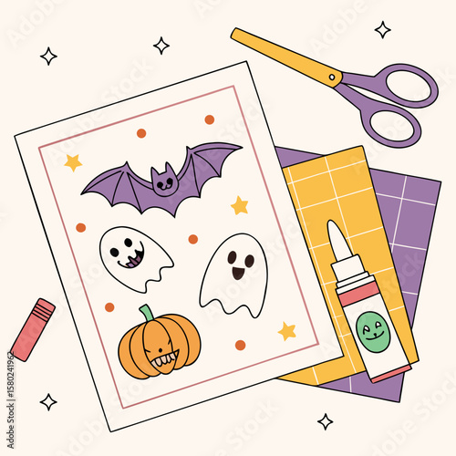 Halloween themed craft project with a bat, ghosts, pumpkin, scissors, and glue on a light background