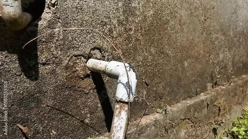 Garden Hose Connected to Water Faucet for Outdoor Use