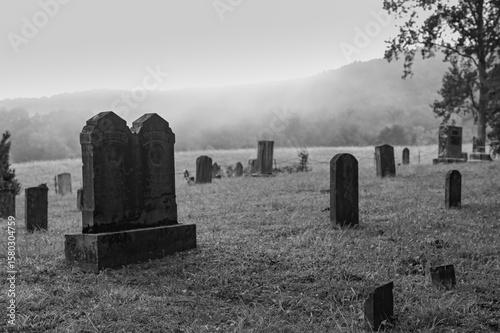 A cemetery in Cades Cove, behind the old Methodist church, on a foggy morning, Great Smoky Mountains, Tennessee, black and white