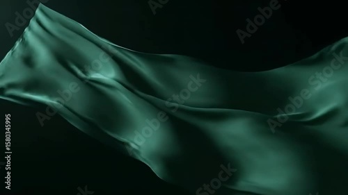 Emerald Green Fabric Flowing in the Dark, Abstract Silk Waves Gently Lit Against a Black Backdrop