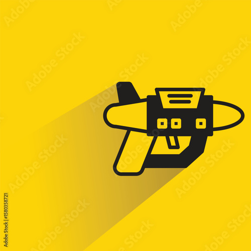 space gun with shadow on yellow background