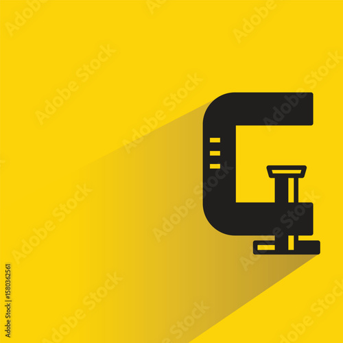 c clamp tool icon with shadow on yellow background