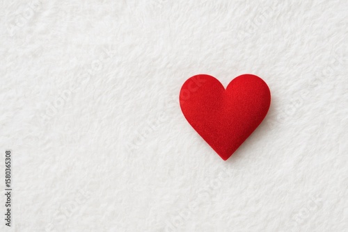 Exploring the theme of love with a heart-shaped object on a gentle white background