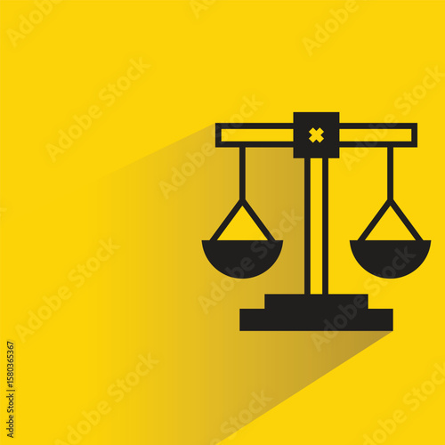 law balance scales icon with shadow on yellow background