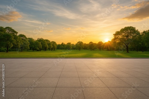 Fototapeta Naklejka Na Ścianę i Meble -  Wide-angle view of an open runway surface adjacent to a lush park during sunset