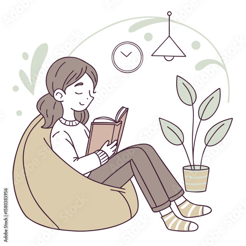 A woman reading a book while sitting on a beanbag chair next to a potted plant and hanging decoration