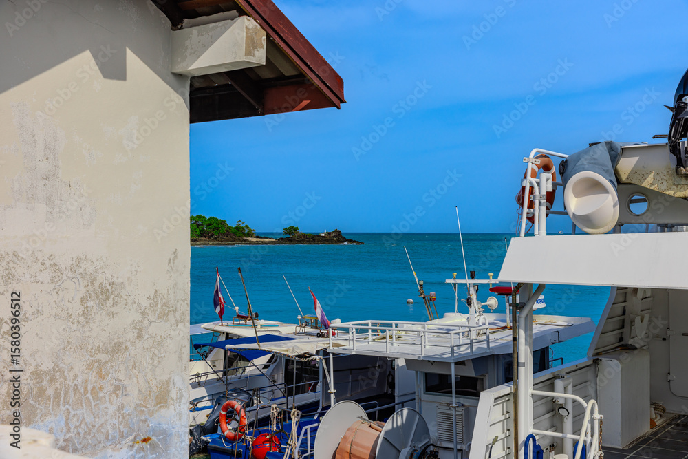 Obraz premium Turquoise blue waters and Lush green islands of the coast of Cape Panwa located on the eastern side of Phuket island in Thailand