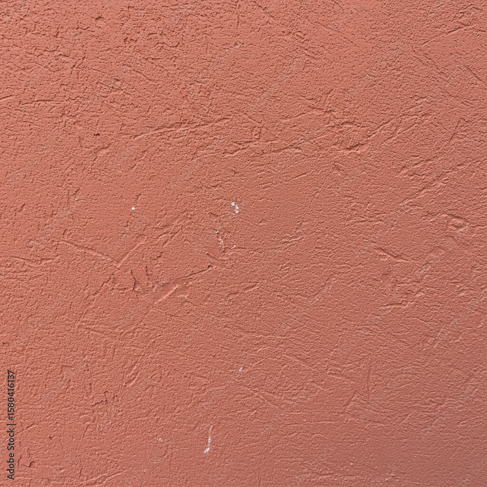 Fototapeta premium Textured salmon-colored wall