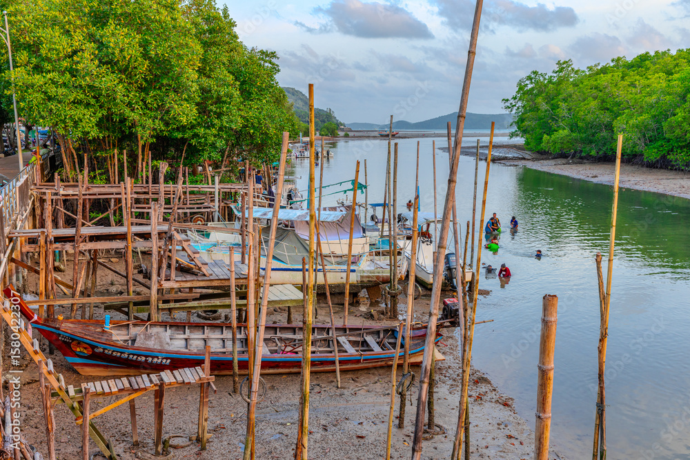 Fototapeta premium Long tail boats moored in Chalong a small river inlet leading into Chalong Bay in the Andaman sea on the island of hurry Thailand