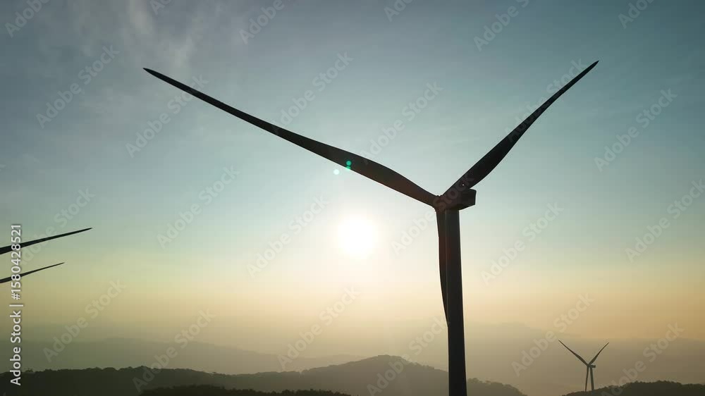 Wind power hill with rotating blades in the brilliant morning sunlight in Da Lat - Vietnam