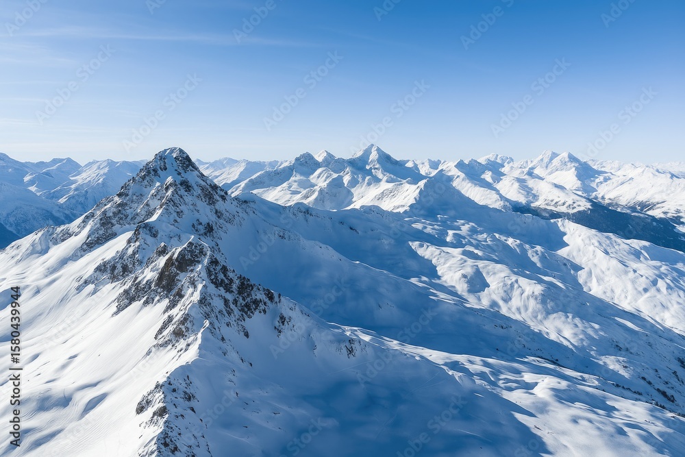 Aerial view of snow-covered mountain tops in the French Alps close to a ski area Aerial view of snow-covered mountain tops in the French Alps close to a ski area