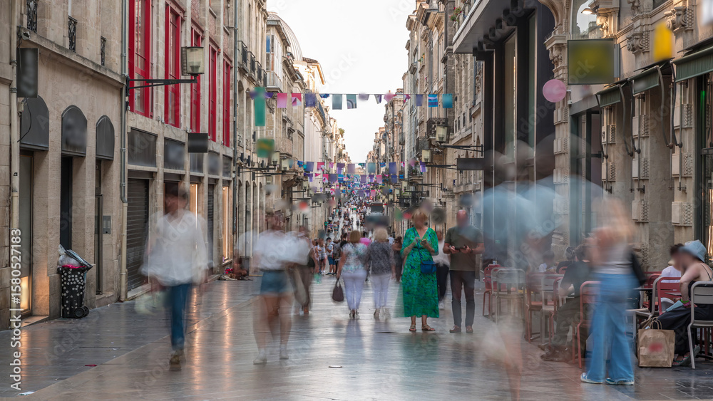 Obraz premium People walking and shopping in Rue Sainte-Catherine timelapse, Bordeaux, France.