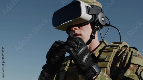 Military personnel uses virtual reality headset for training in open field under clear sky