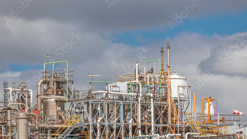 Distillation Columns and their process equipment of hydrogen plant timelapse with clouds on a background.