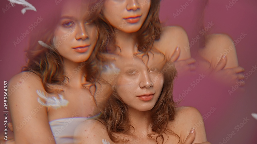 Obraz premium Portrait of beautiful young woman on pink background studio