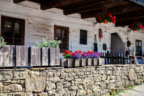 Charming Traditional White Wooden House with Flower Boxes