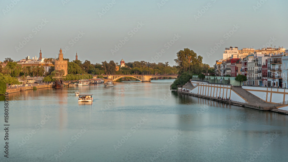 Naklejka premium Aerial view of Seville divided by the river Guadalquivir timelapse hyperlapse